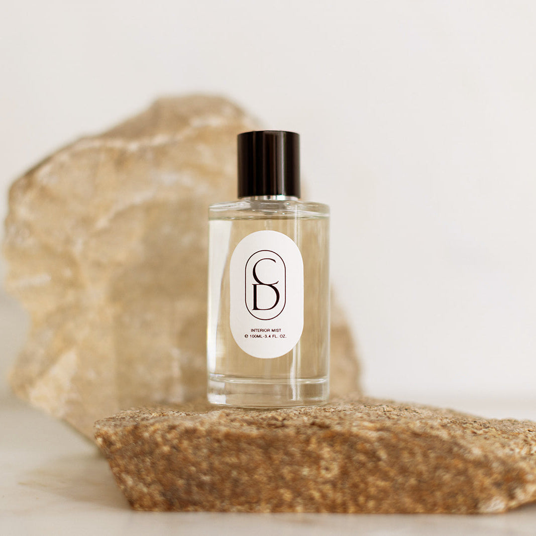 Perfume bottle with a label on a stone surface