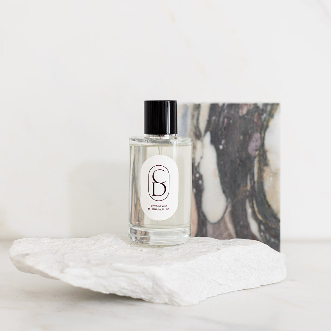 Perfume bottle with a decorative label on a marble surface